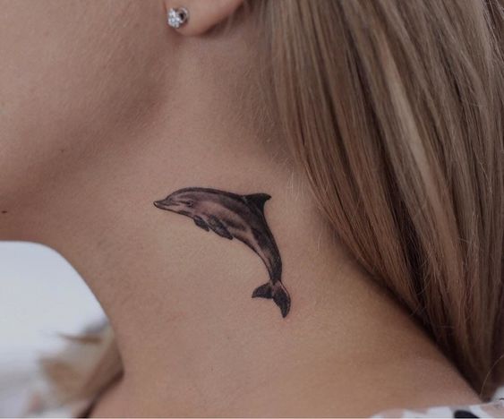 Tattoo of a dolphin on the neck for women