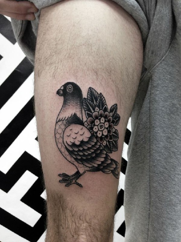 Tattoo of a dove on the thigh for men