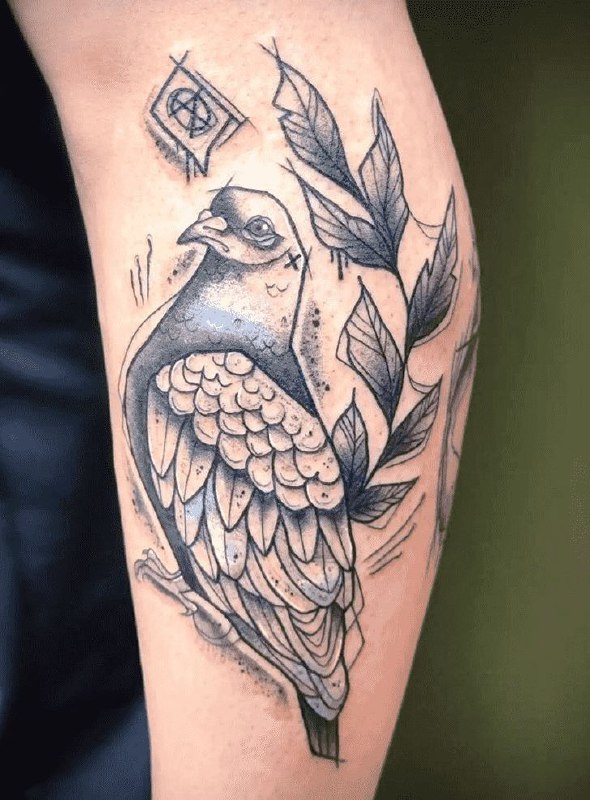 Large tattoo of a dove on the shin for men