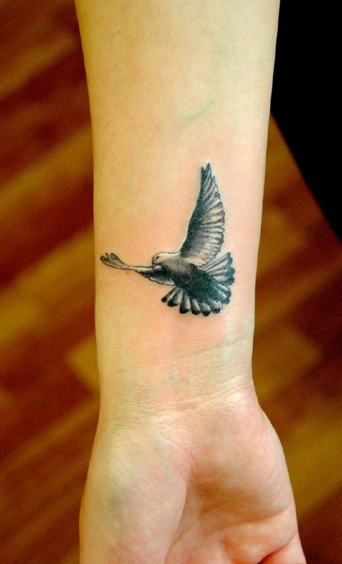 Tattoo of a dove on the forearm for women