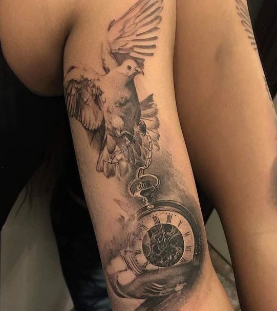 Tattoo of a dove and a clock on the shin for women