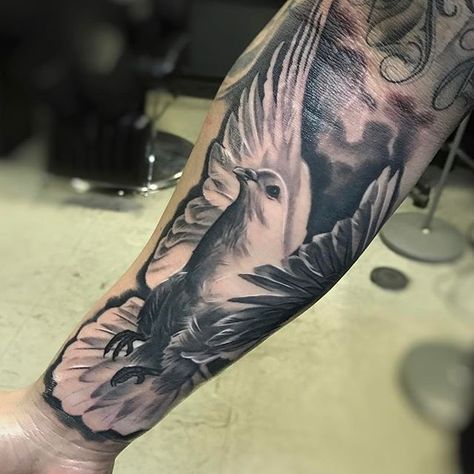 Large tattoo of a dove on the forearm for men