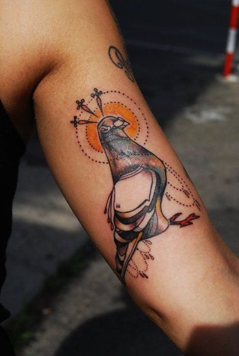 Color tattoo of a dove on the shoulder for women