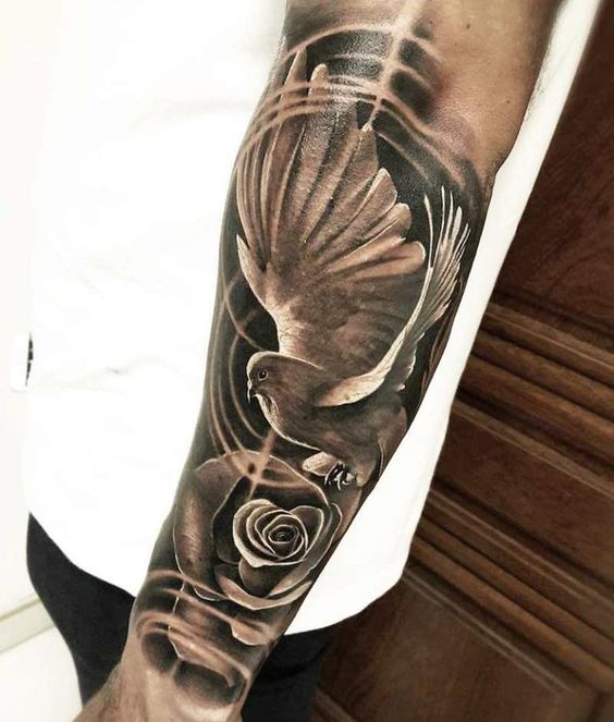 Large tattoo of a dove and a rose on the forearm for men