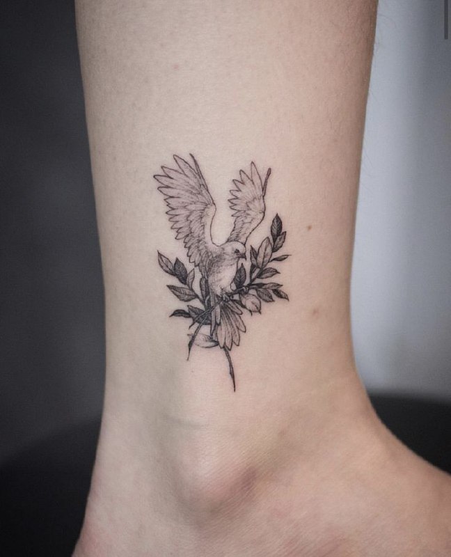 Tattoo of a dove on the shin for men