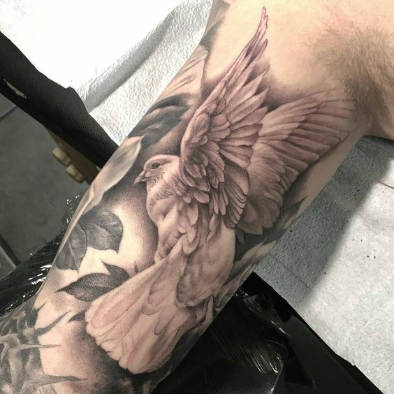 Large tattoo of a dove on the arm for men