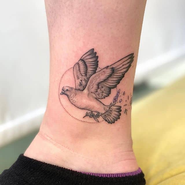 Tattoo of a dove on the shin for women