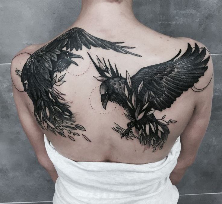 Tattoo of two ravens on the back for women