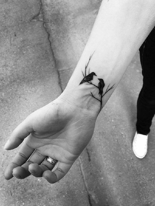 Tattoo of two crows on the wrist for men