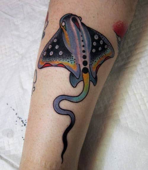 Colored stingray tattoo on the forearm for men