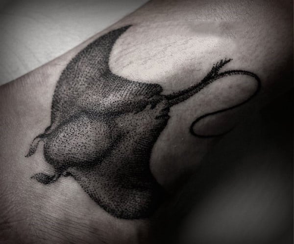 Large stingray tattoo on the ankle for men