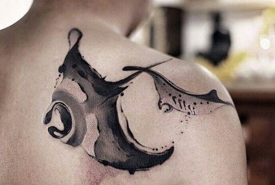 Tattoo of two stingrays on the shoulder blade for men