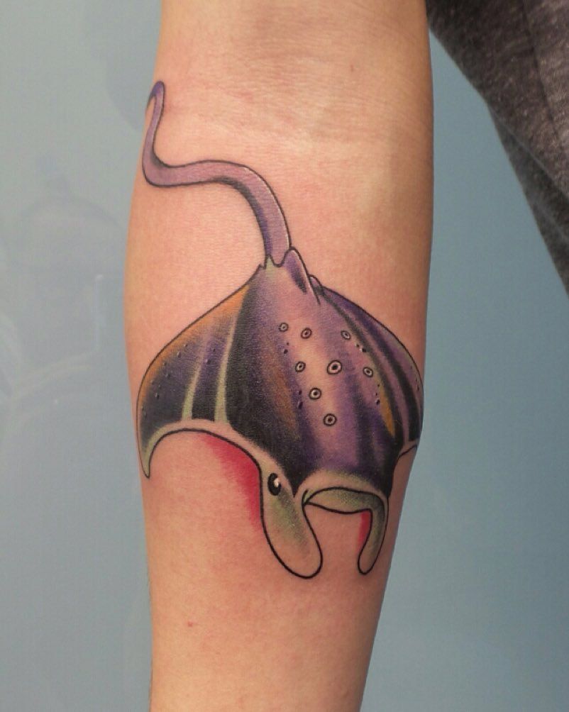 Color tattoo of a stingray on the arm for women