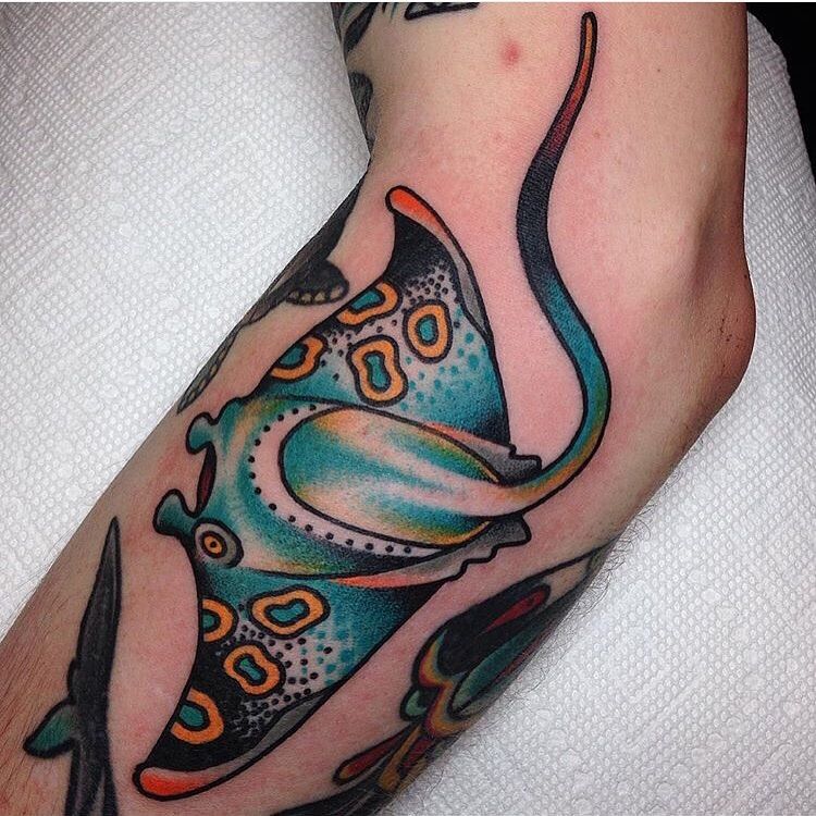 Colored stingray tattoo on the forearm for men