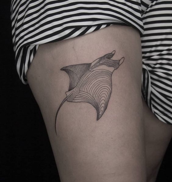 Tattoo of a stingray on the thigh for women