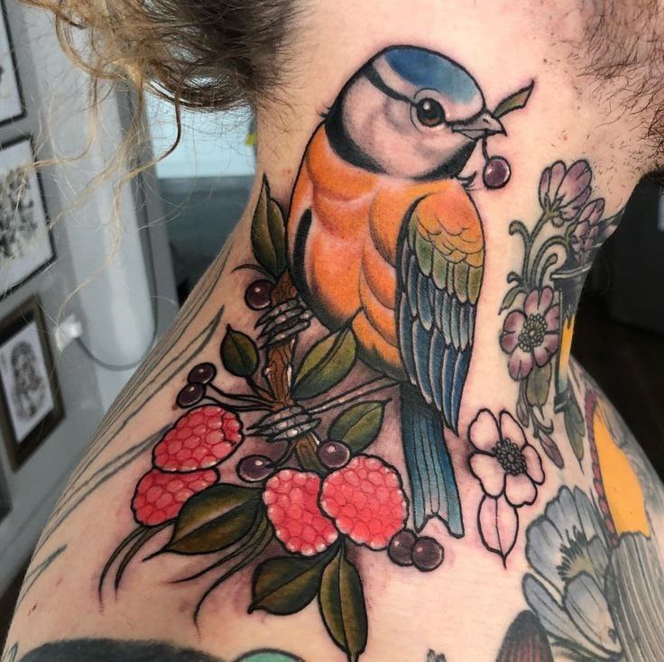 Large tit tattoo with raspberries on the neck for women