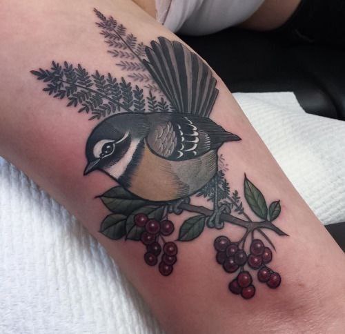 Tattoo of a tit with berries on an ankle for women