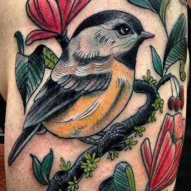 Large tattoo of a tit and flowers on the shoulder for men