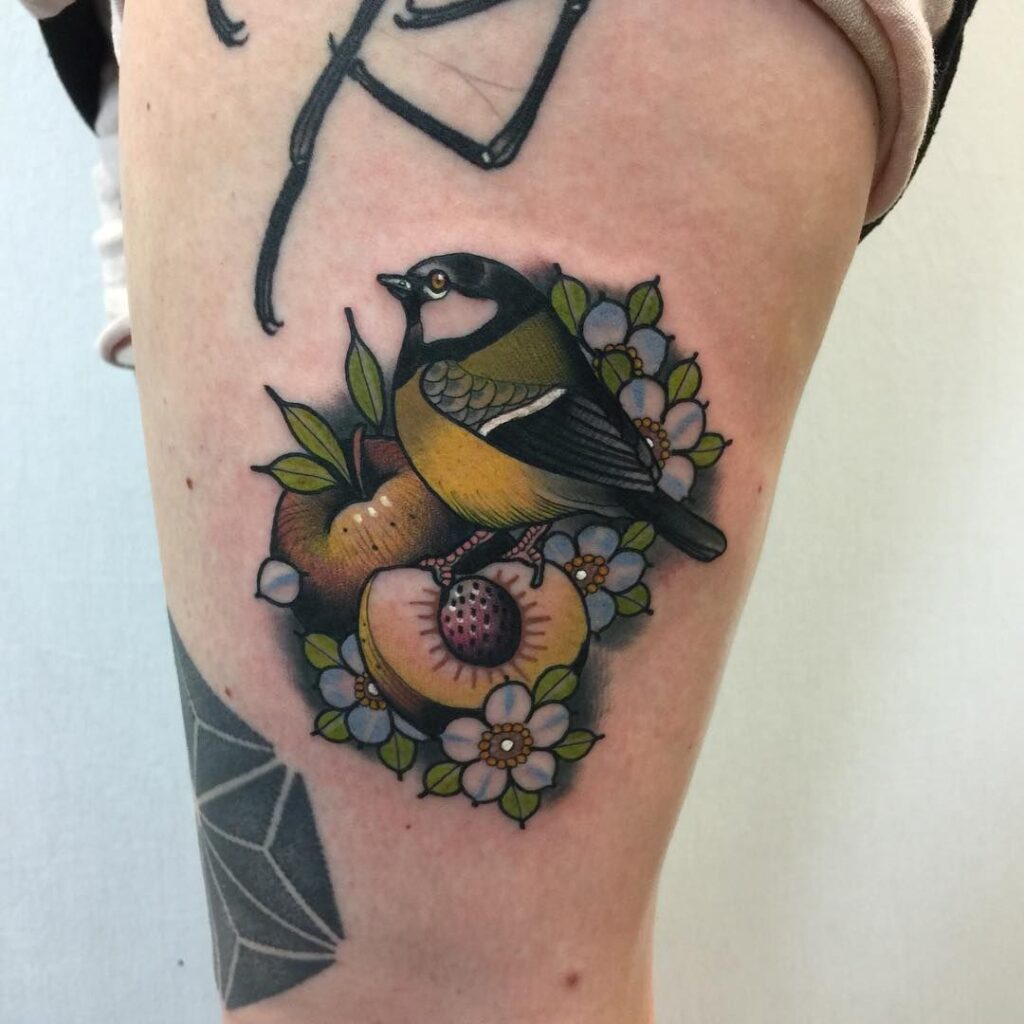 Colorful tattoo of tits and peaches on the thigh for women