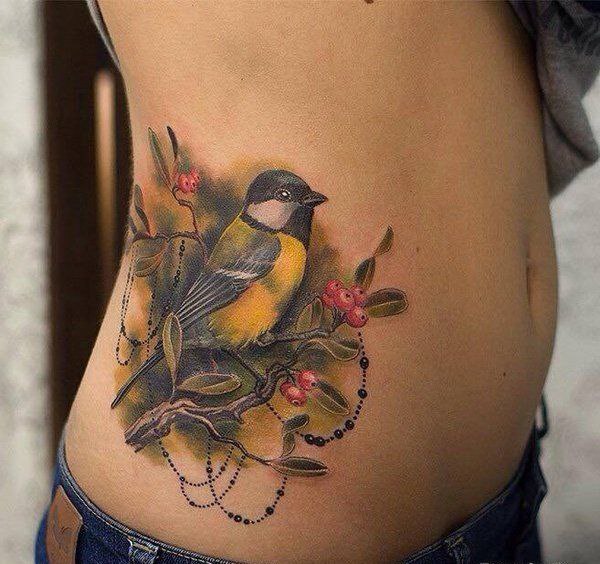 Large tit tattoo with berries on the side for women