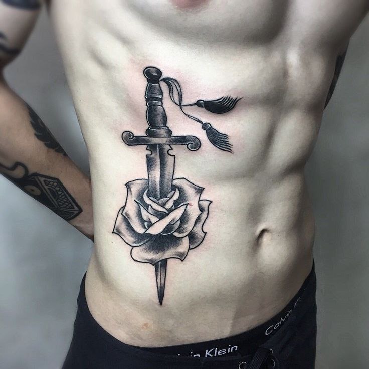 Rose and dagger tattoo on the side for men