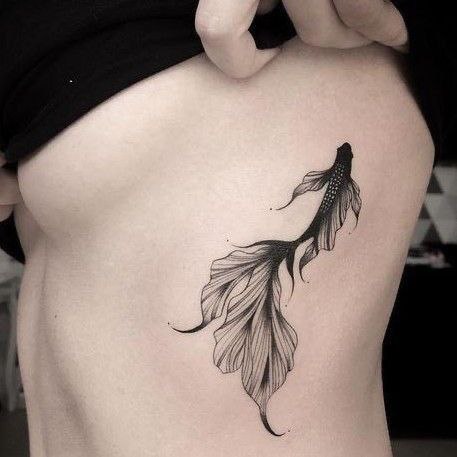 Fish tattoo on the side for women