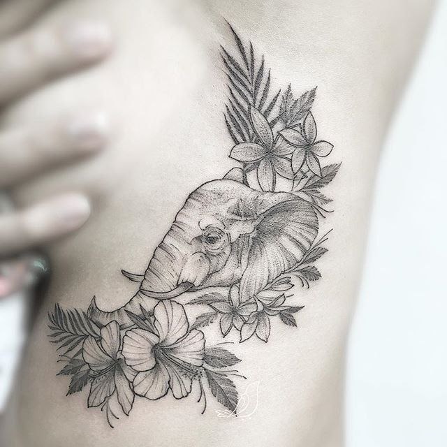 Elephant and flowers tattoo on the side for women