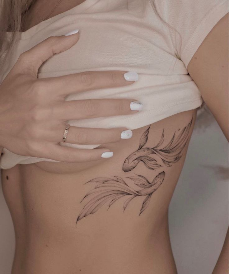 Koi fish tattoo on the side for women