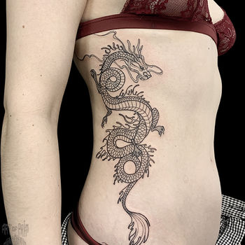 Large dragon tattoo on the side for women