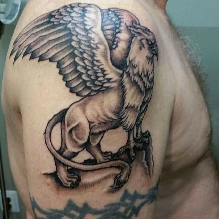 Large griffin tattoo on the shoulder for men