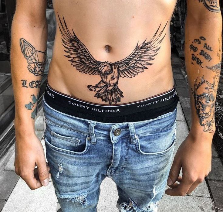 Tattoo of a raven on the stomach for men