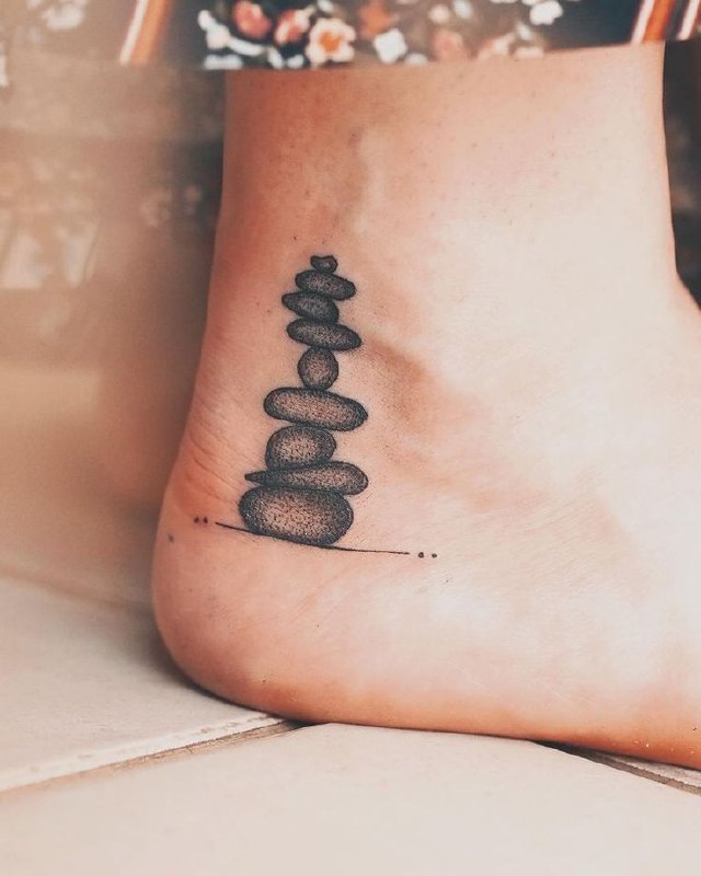 Ankle stone tattoo for women