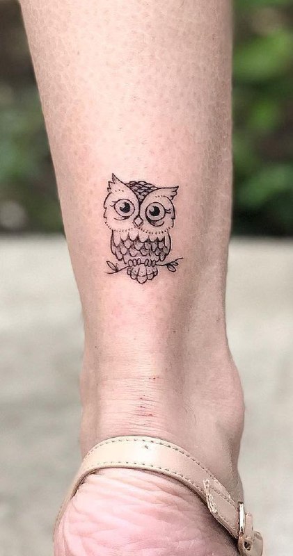 Tattoo of an owl on a calf for women