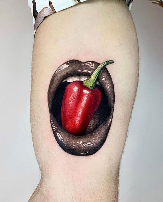 Large pepper tattoo on the biceps for women