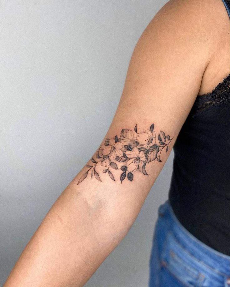 Flower tattoo on the biceps for women