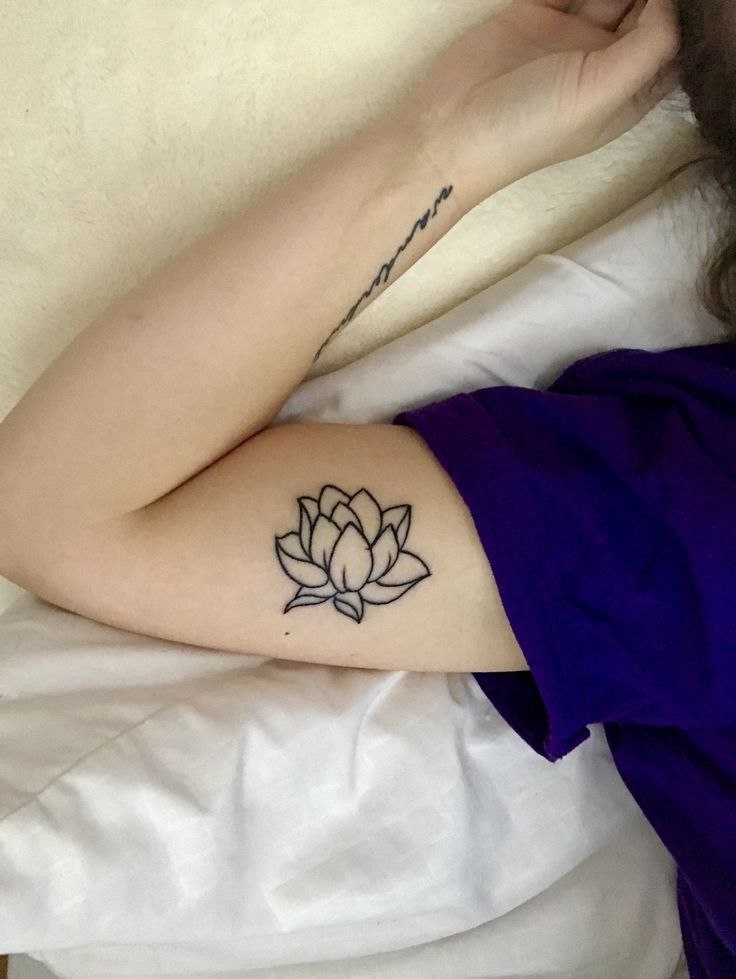 Lotus tattoo on the biceps for women