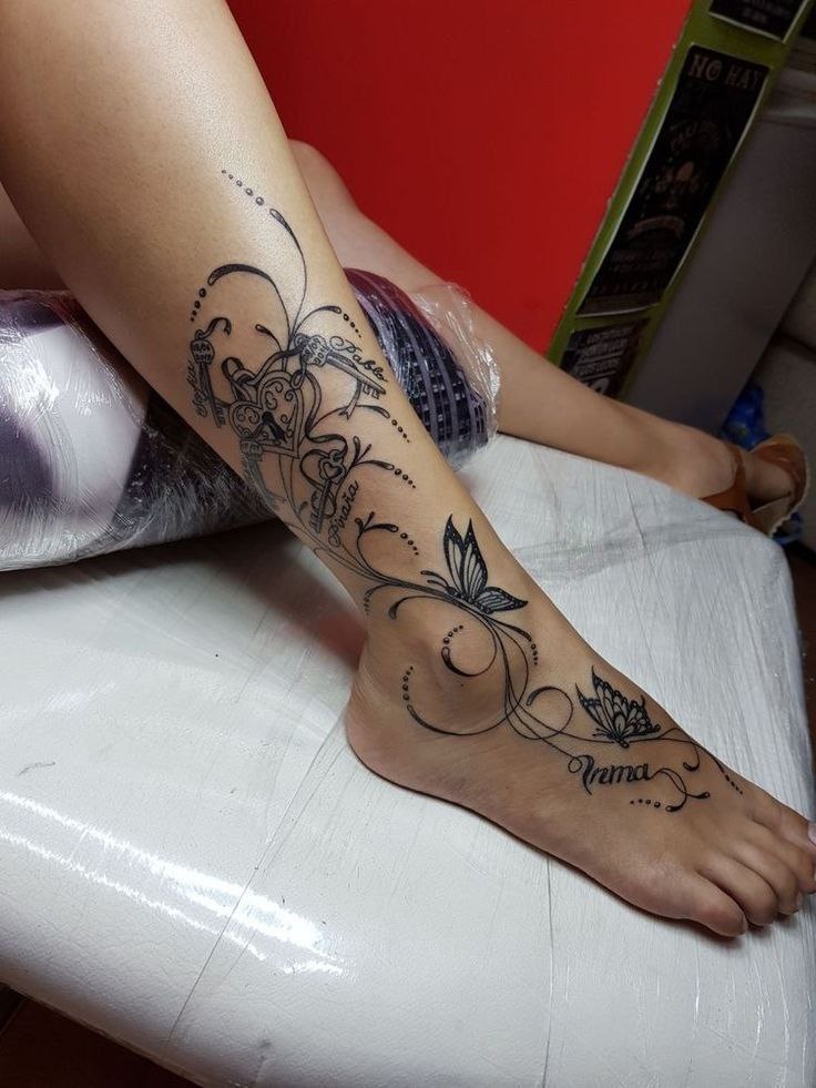 Large butterfly tattoo with an inscription on the ankle for women