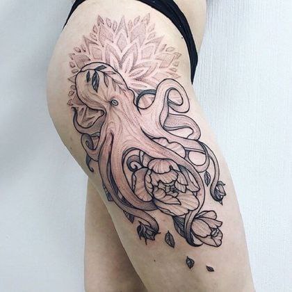 Large octopus tattoo on the thigh for women