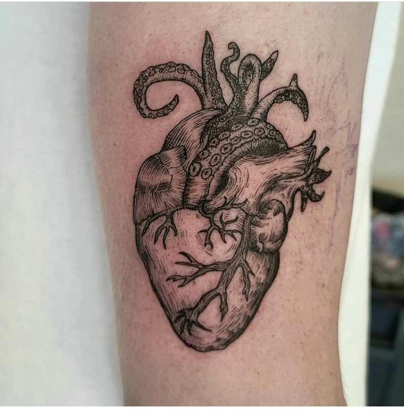 Tattoo of an octopus and heart on the shin for women