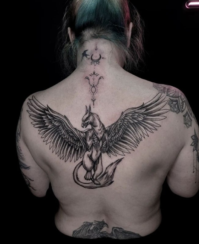 Large griffin tattoo on the back for women