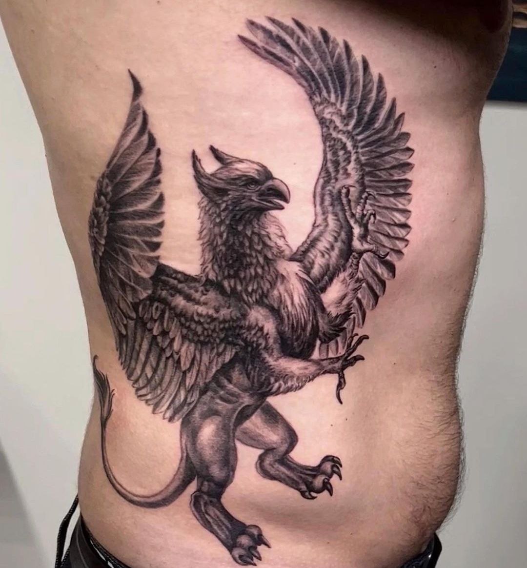 Large griffin tattoo on the side for men