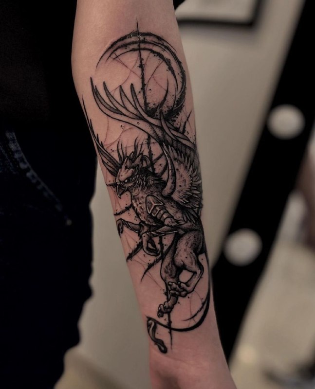 Tattoo of a griffin on the forearm for men