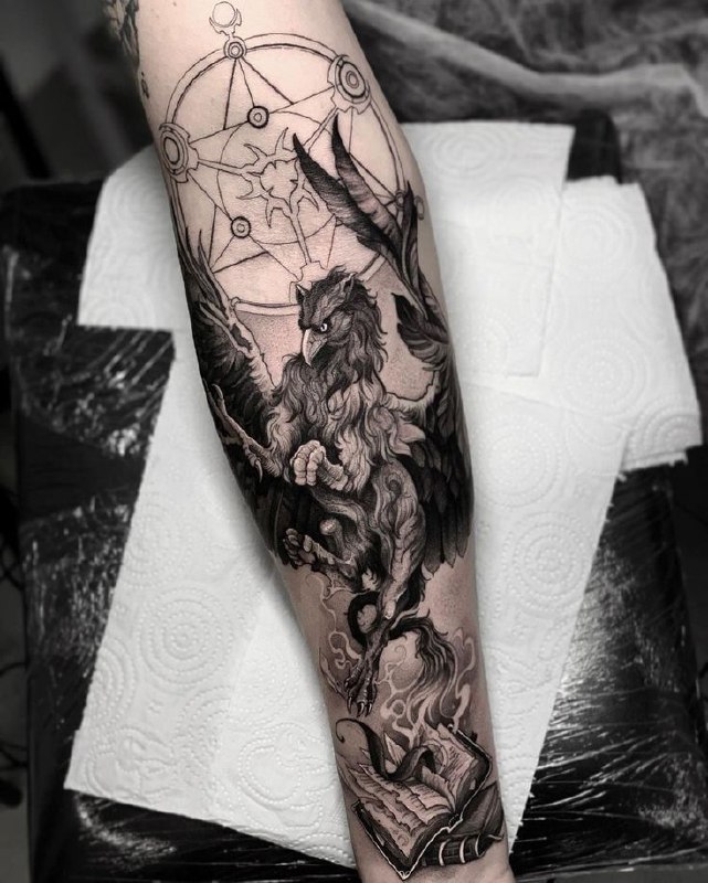 Tattoo of a griffin on the forearm for men