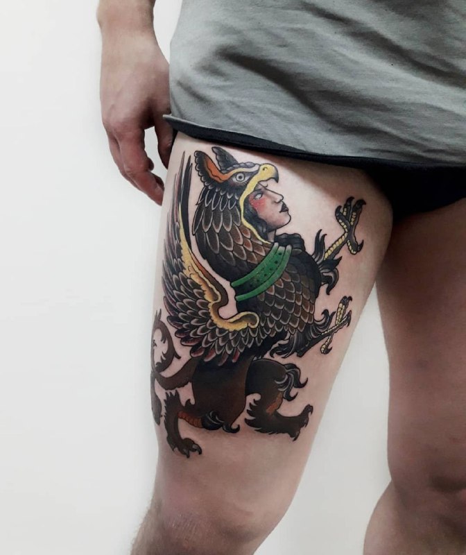 Colored griffin tattoo on the hip for men