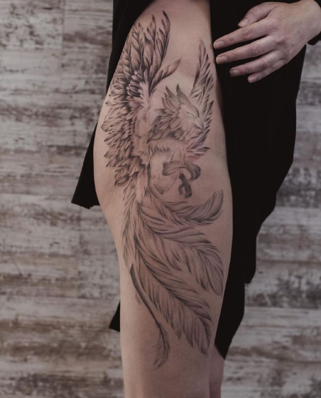 Large griffin tattoo on the thigh for women