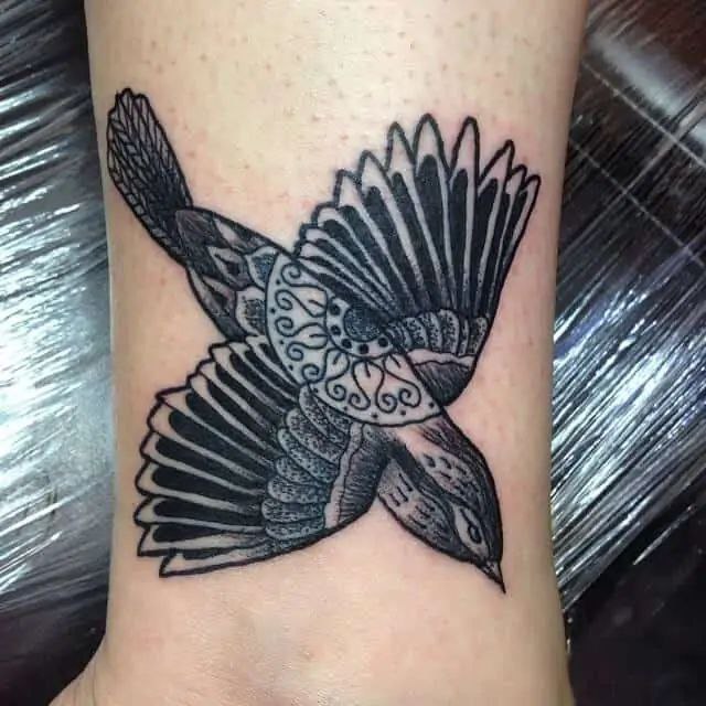 Large sparrow tattoo on the arm for women