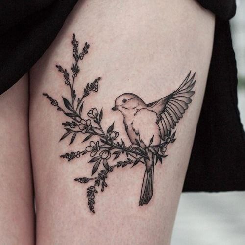 Sparrow tattoo with flowers on the thigh for women