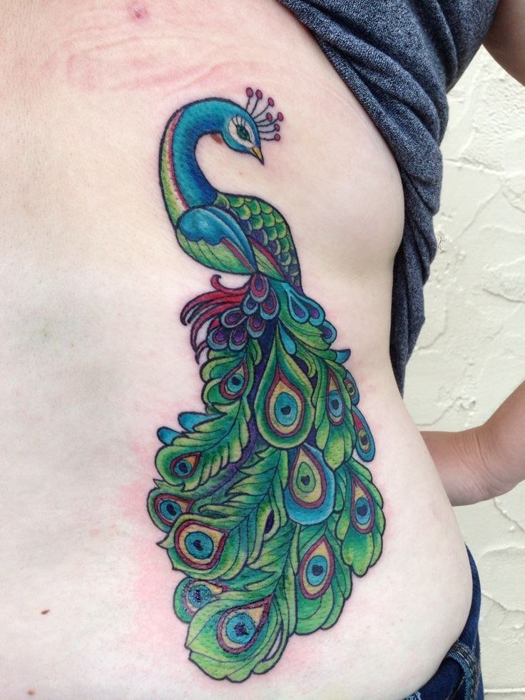 Colorful peacock tattoo on the back for women