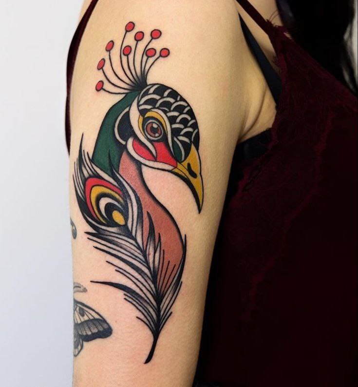 Colorful peacock tattoo on the shoulder for women