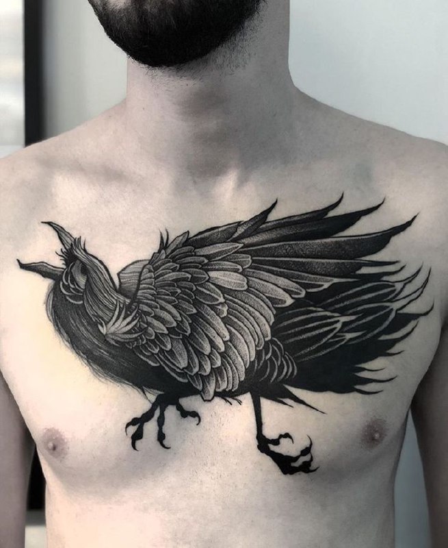 Large raven tattoo on the chest for men